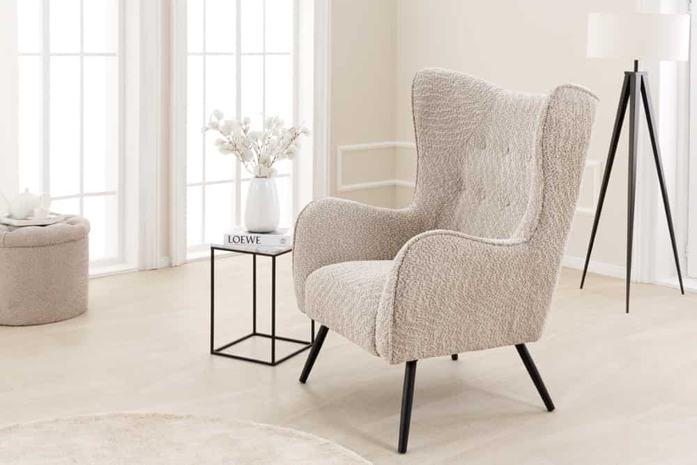 Wing chair AMSTERDAM bouclé greige black metal legs